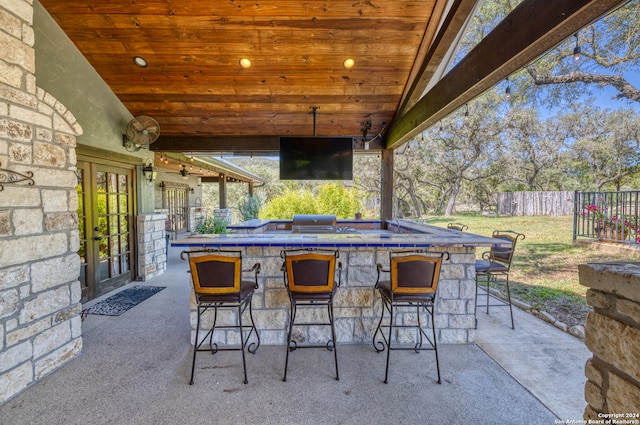 view of patio featuring exterior bar, a grill, and french doors