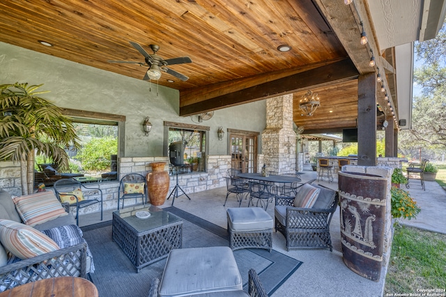 view of patio / terrace with an outdoor bar, area for grilling, ceiling fan, and outdoor lounge area