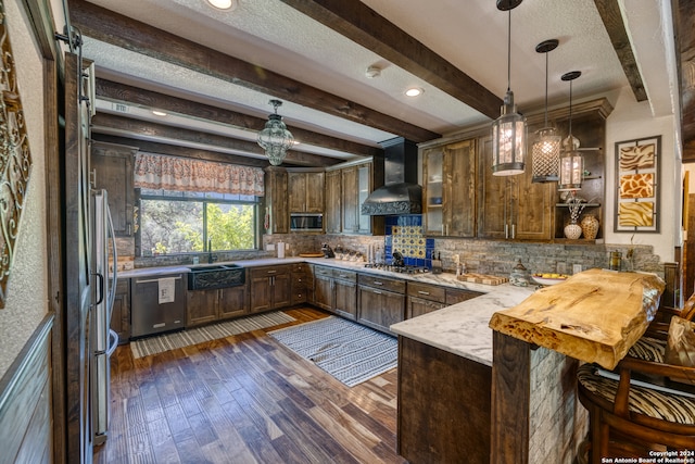 kitchen featuring kitchen peninsula, beam ceiling, dark hardwood / wood-style flooring, and wall chimney range hood