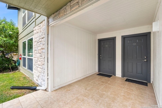 entrance to property featuring stone siding