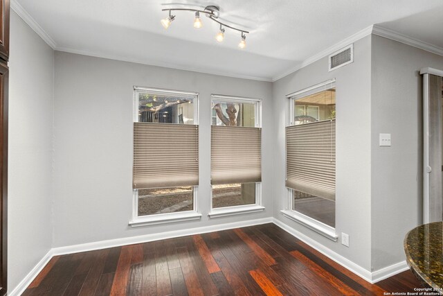 unfurnished dining area featuring hardwood / wood-style flooring and crown molding