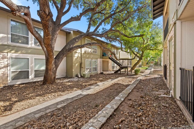 view of side of home featuring stairway