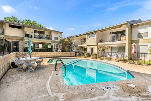 view of swimming pool with a patio