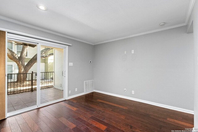 empty room with recessed lighting, ornamental molding, wood-type flooring, baseboards, and visible vents