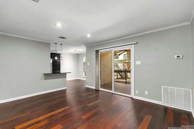 unfurnished living room featuring ornamental molding, dark wood-style floors, and visible vents