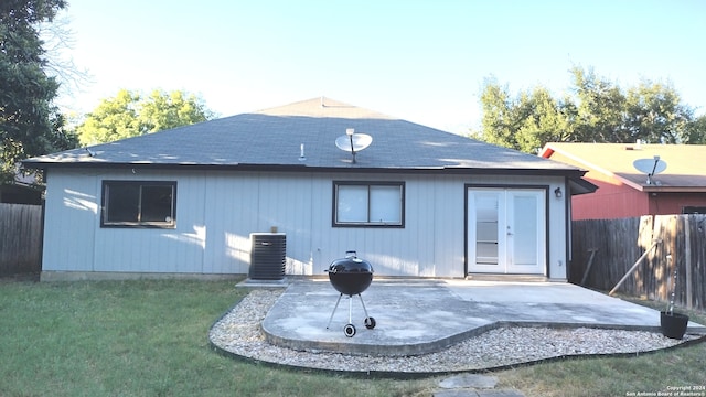 rear view of house featuring a patio, a yard, and central AC unit