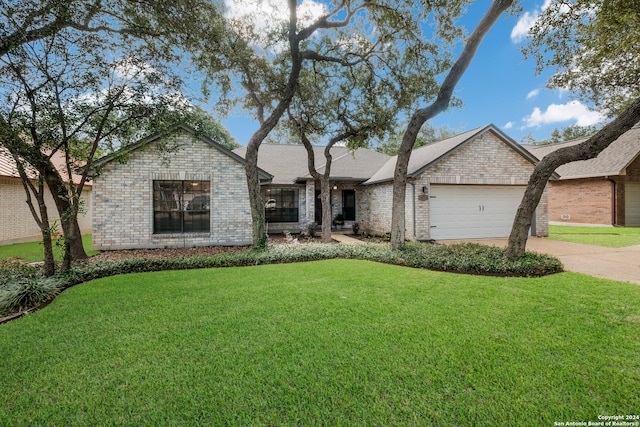 ranch-style house featuring a garage and a front lawn