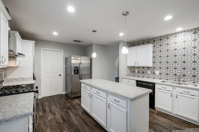 kitchen with a center island, dark wood-type flooring, white cabinetry, hanging light fixtures, and stainless steel appliances