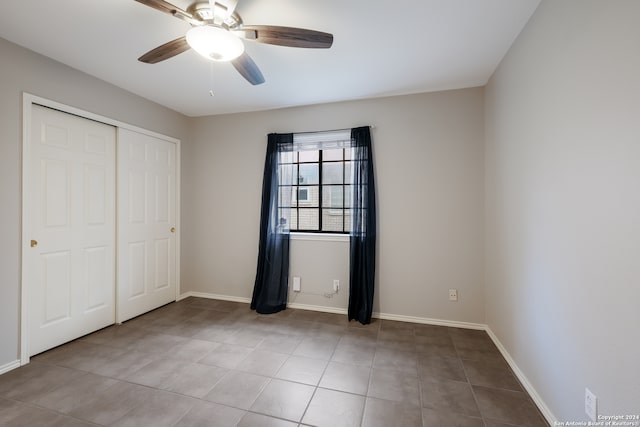 unfurnished bedroom featuring light tile patterned floors, ceiling fan, and a closet