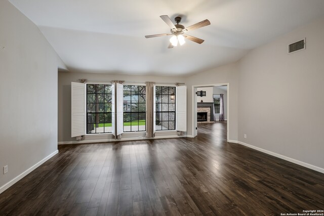 unfurnished living room featuring ceiling fan, vaulted ceiling, and dark hardwood / wood-style flooring