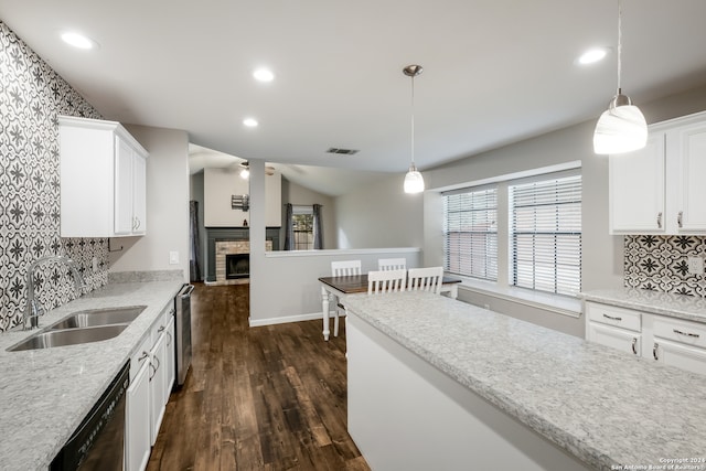 kitchen with pendant lighting, white cabinetry, dark wood-type flooring, and backsplash