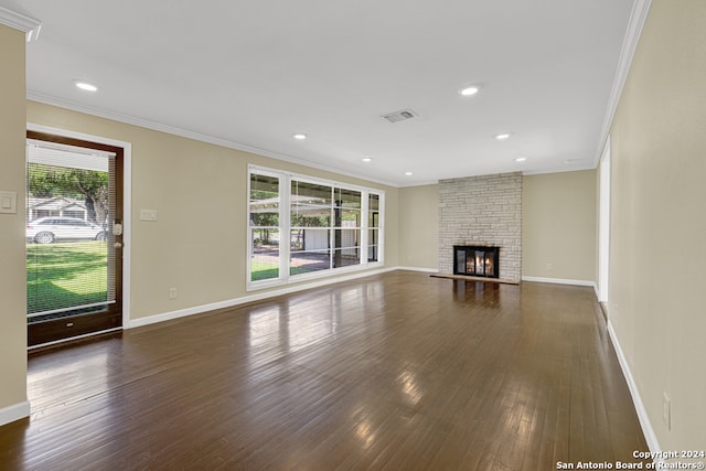 unfurnished living room with a fireplace, dark hardwood / wood-style floors, and crown molding