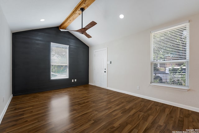 unfurnished room featuring vaulted ceiling with beams, a healthy amount of sunlight, ceiling fan, and dark wood-type flooring