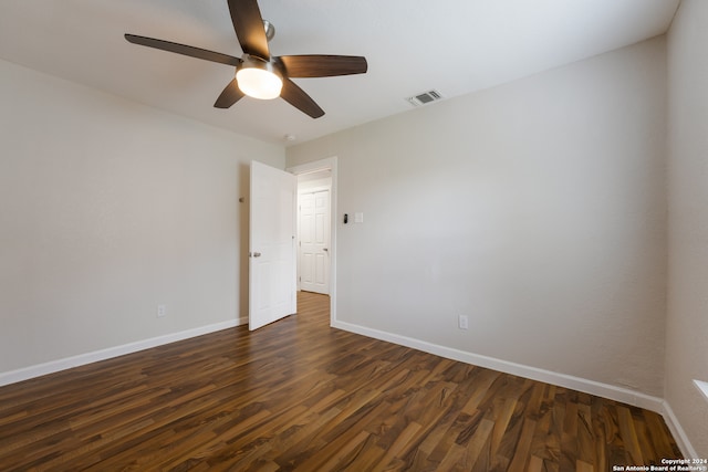 empty room with ceiling fan and dark wood-type flooring