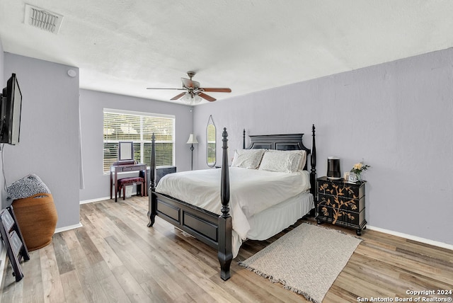 bedroom with ceiling fan and hardwood / wood-style flooring