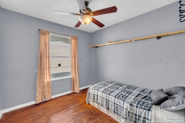 bedroom featuring ornamental molding, ceiling fan, and hardwood / wood-style floors