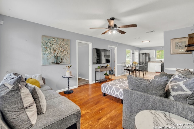 living room with ceiling fan and hardwood / wood-style flooring