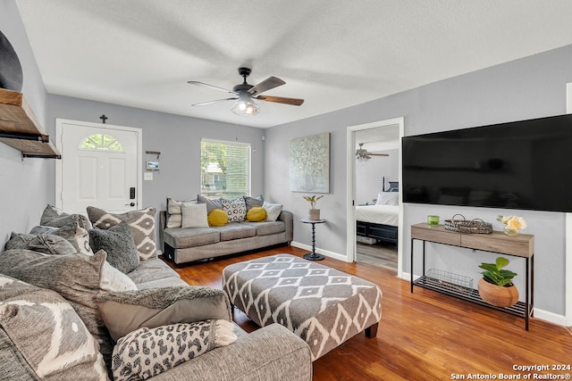 living room with ceiling fan and hardwood / wood-style floors