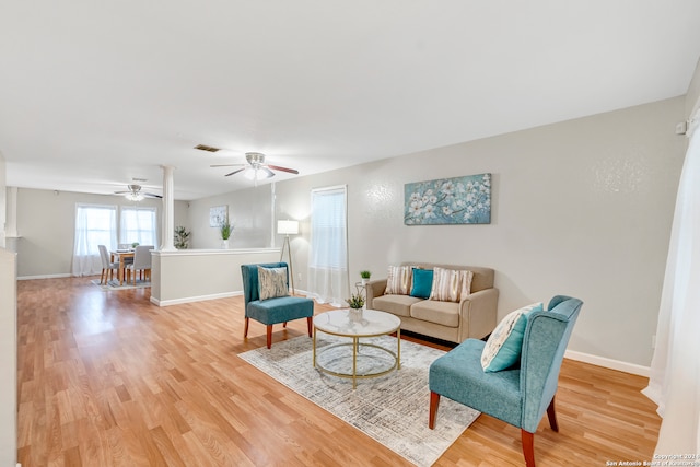 living room with wood-type flooring and ceiling fan