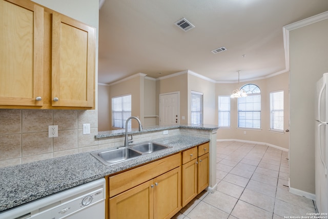 kitchen with sink, white appliances, light brown cabinetry, a notable chandelier, and decorative backsplash