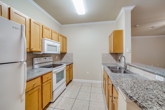 kitchen featuring light stone countertops, white appliances, backsplash, and sink