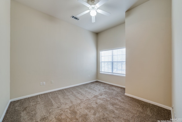 spare room featuring ceiling fan and light colored carpet