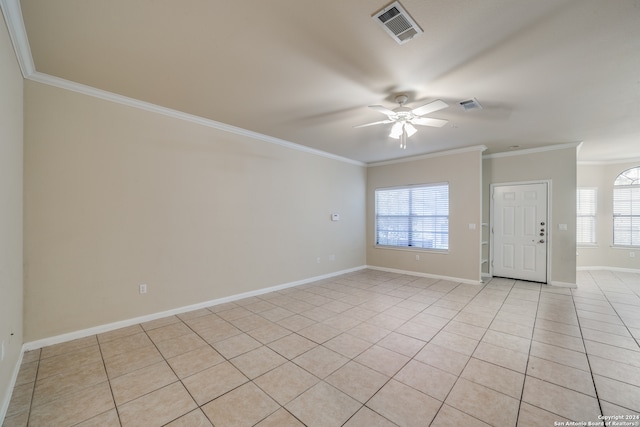 spare room with light tile patterned floors, ornamental molding, and ceiling fan