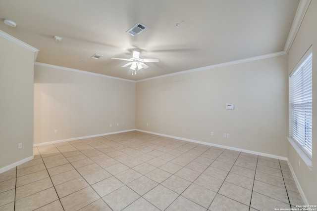 spare room featuring ceiling fan, light tile patterned flooring, crown molding, and a wealth of natural light