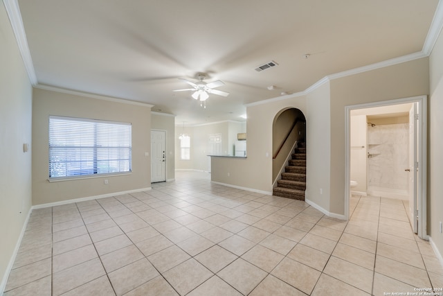 unfurnished room with ceiling fan, crown molding, and light tile patterned floors