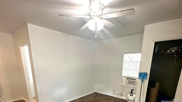 unfurnished bedroom with ceiling fan, cooling unit, a closet, and dark hardwood / wood-style floors