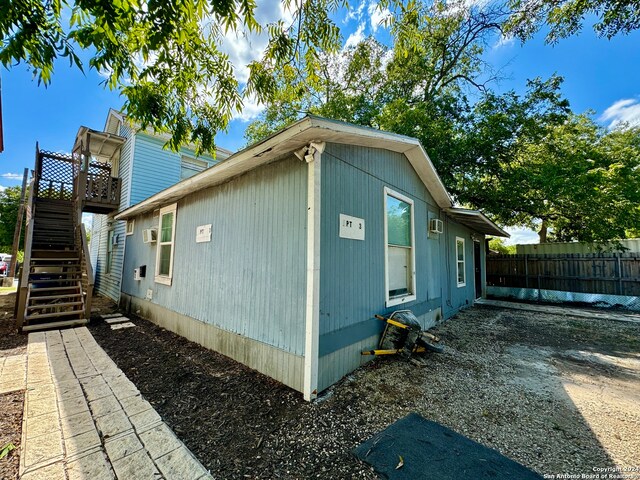 view of side of home with a wooden deck