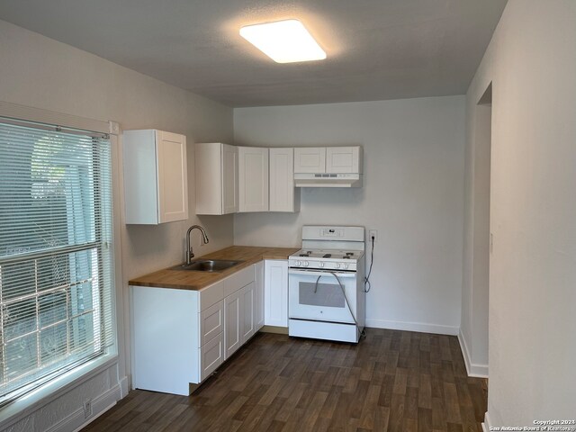 kitchen featuring dark hardwood / wood-style floors, sink, white gas range oven, and white cabinets