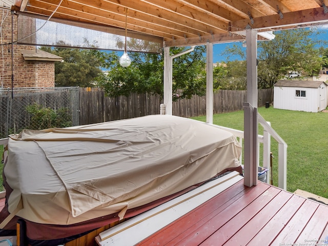 deck with a storage shed and a yard