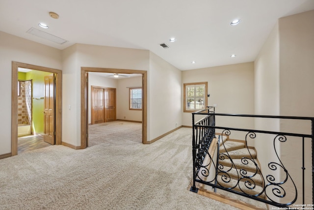 hall with light colored carpet