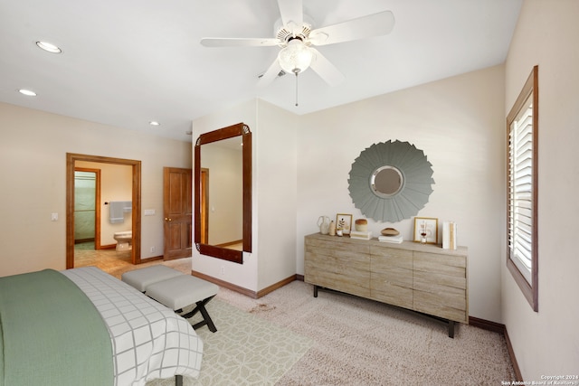 carpeted bedroom featuring ceiling fan and ensuite bath