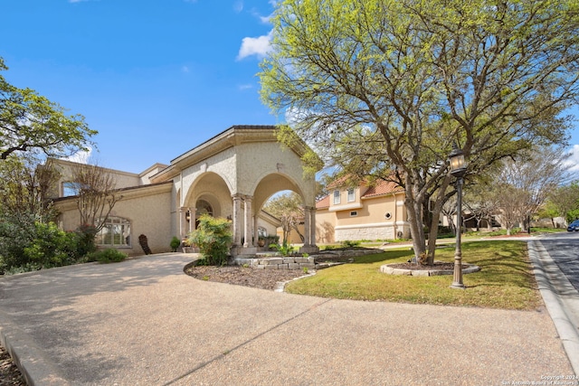 mediterranean / spanish home featuring a front yard