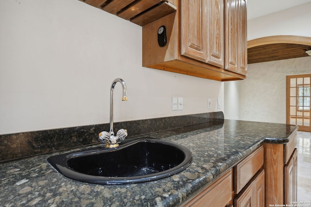 kitchen with dark stone counters and sink