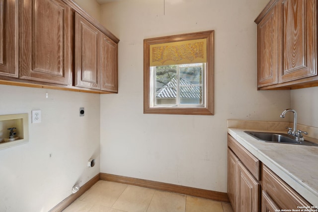 laundry room featuring hookup for a washing machine, hookup for an electric dryer, light tile patterned floors, cabinets, and sink