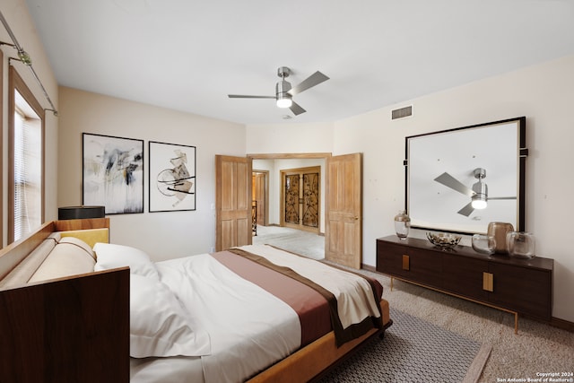 bedroom with ceiling fan and light colored carpet