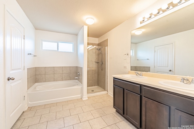 bathroom featuring vanity, separate shower and tub, a textured ceiling, and tile patterned floors