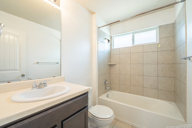 full bathroom featuring tiled shower / bath combo, tile patterned flooring, vanity, and toilet