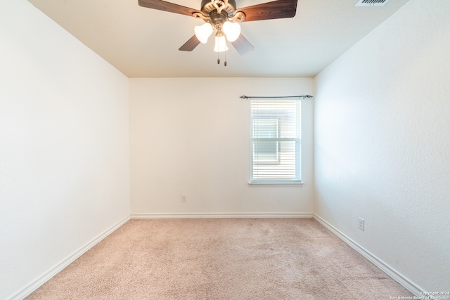 empty room with ceiling fan and light colored carpet