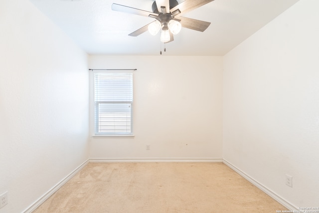 empty room with ceiling fan and light colored carpet