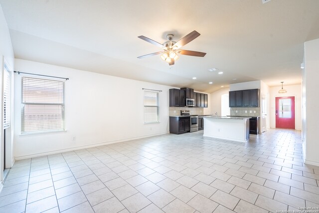 unfurnished living room with light tile patterned floors, ceiling fan, and plenty of natural light