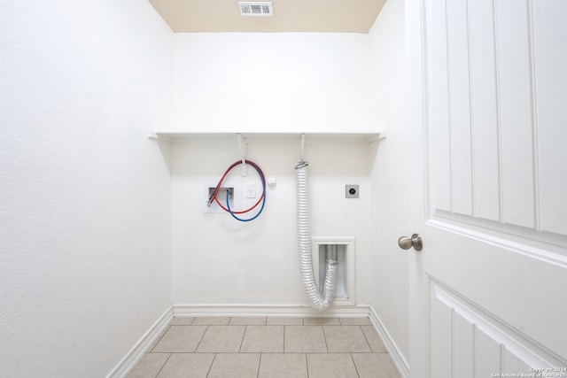 washroom featuring hookup for a washing machine, light tile patterned flooring, and hookup for an electric dryer