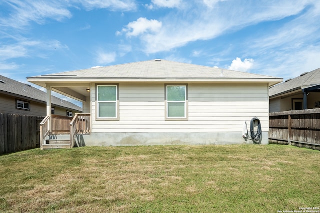 rear view of house with a lawn