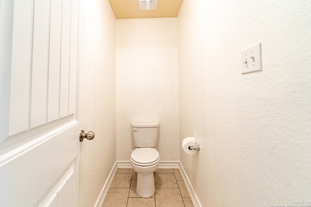 bathroom featuring toilet and tile patterned floors