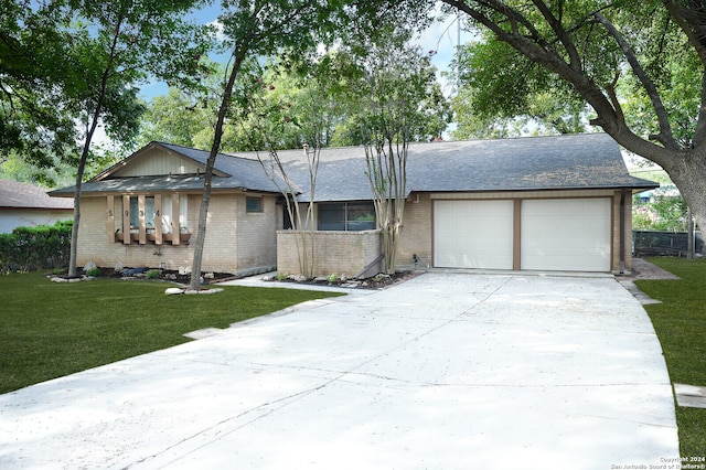 ranch-style home featuring a garage and a front yard