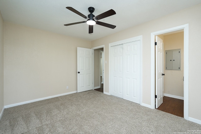 unfurnished bedroom with ceiling fan, a closet, and carpet flooring