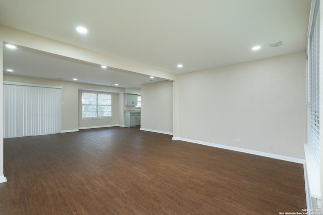 unfurnished room featuring dark wood-type flooring